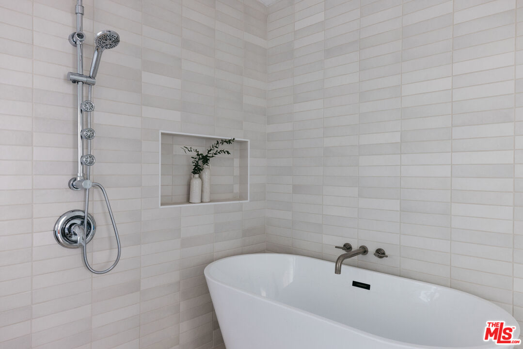5907 Meridian Street Los Angeles, CA 90042 - Photo 17 of 27 a bathroom with a tub and a shower