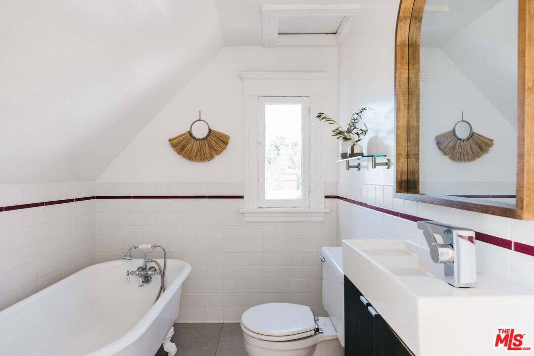 5907 Meridian Street Los Angeles, CA 90042 - Photo 20 of 27 a bathroom with a sink vanity mirror and toilet