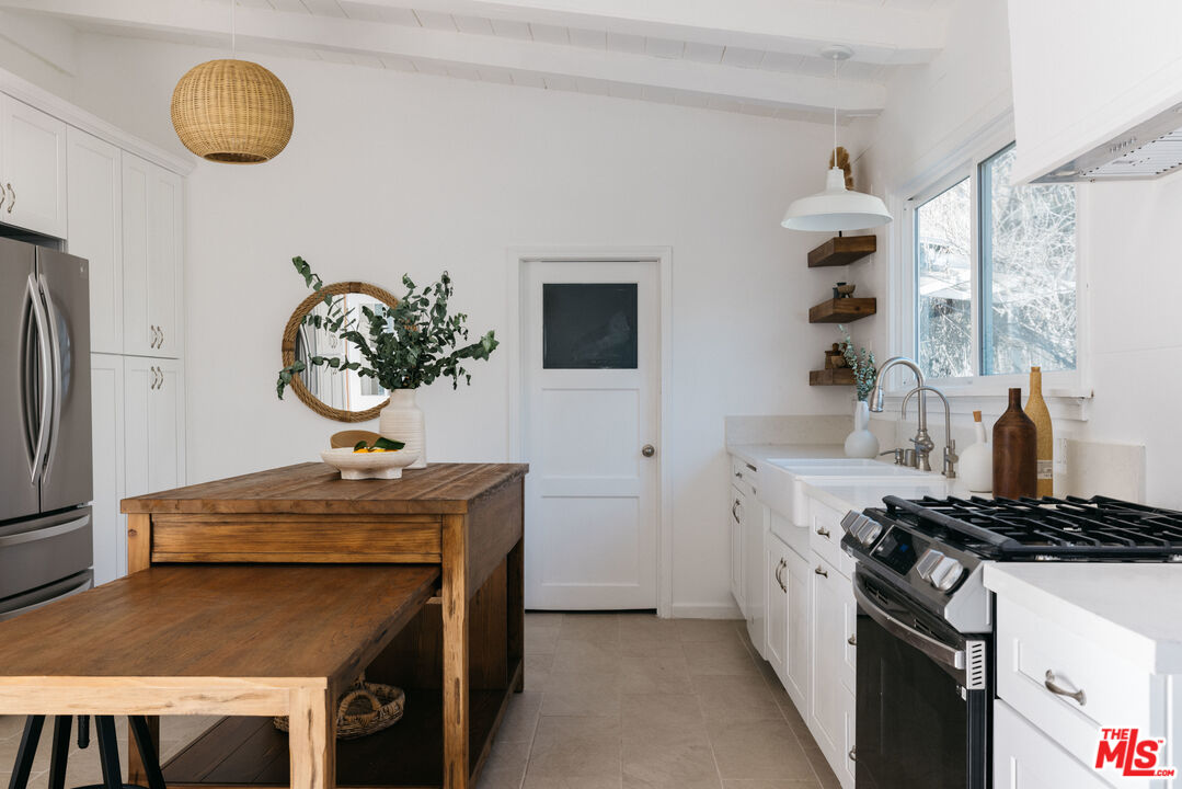 5907 Meridian Street Los Angeles, CA 90042 - Photo 10 of 27 a kitchen with stainless steel appliances granite countertop a stove and a sink