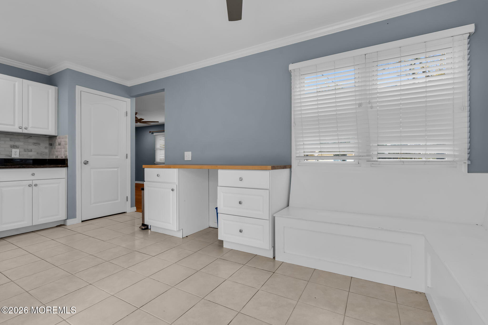 593 Beach Plum Road Brick, NJ 08723 - Photo 17 of 38 a kitchen with white cabinets and white appliances