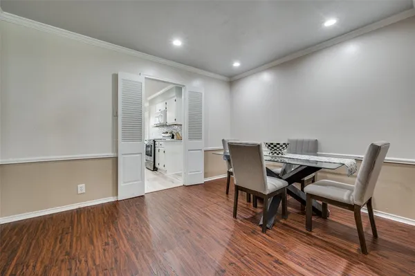 a view of a dining room with furniture and wooden floor