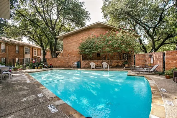 a front view of a house with a yard and sitting area