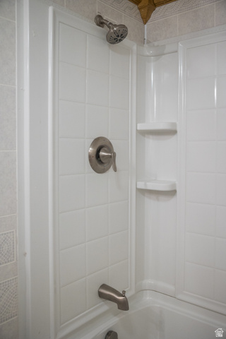 634 South 2100th Street West Vernal, UT 84078 - Photo 42 of 71 Bathtub and shower combination featuring a brushed nickel showerhead, coordinating brushed nickel tub spout, and a single handle control