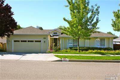 5708 Evening Way Santa Rosa, CA 95409 - Photo 1 of 1 a front view of a house with a garden and trees