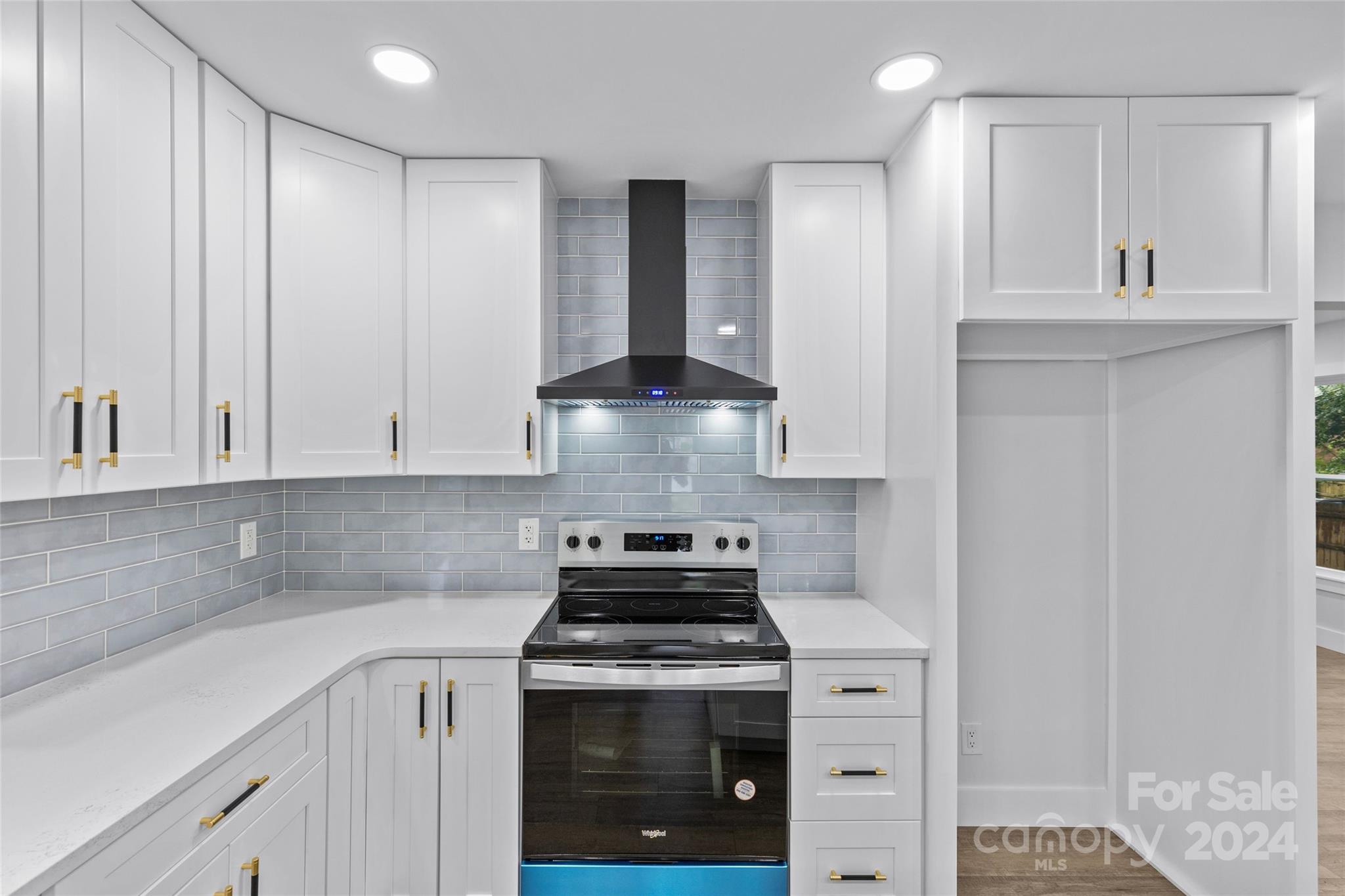 5745 Ruth Drive Charlotte, NC 28215 - Photo 12 of 42 a kitchen with stainless steel appliances granite countertop white cabinets and a stove