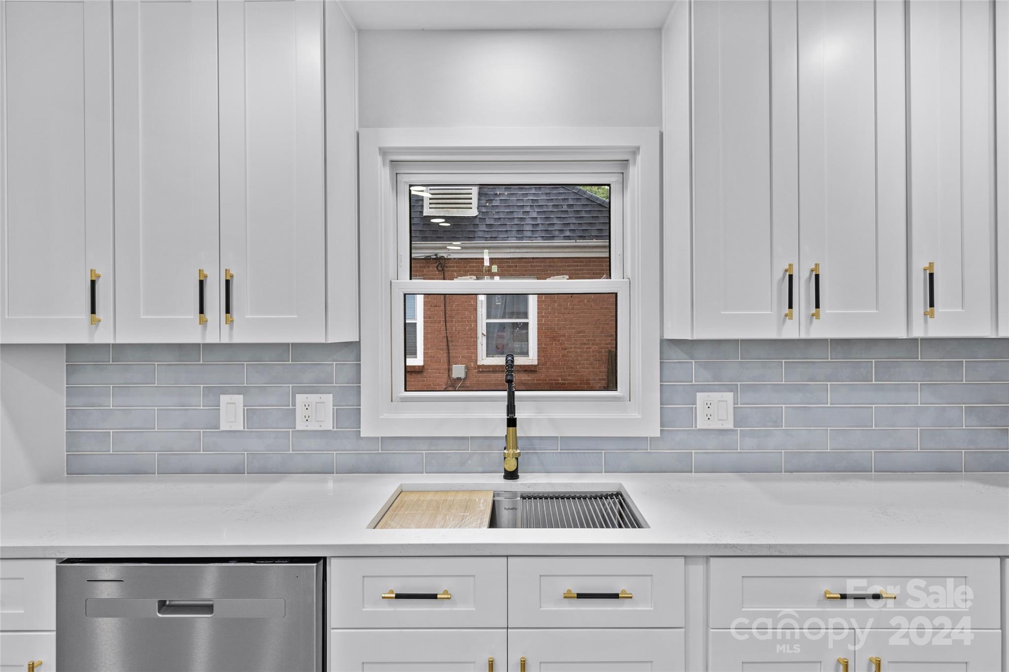 5745 Ruth Drive Charlotte, NC 28215 - Photo 13 of 42 a kitchen with white cabinets and a sink