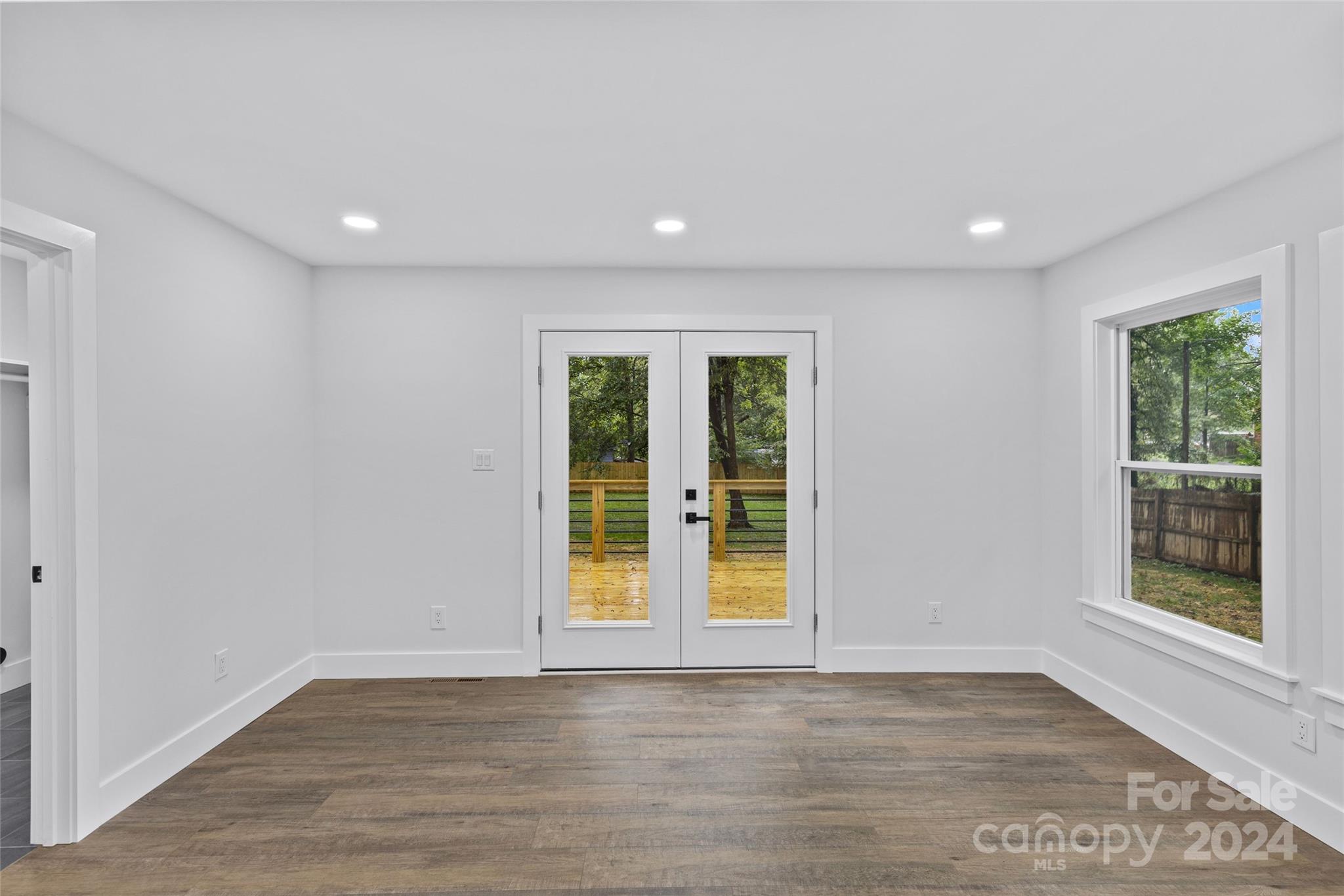5745 Ruth Drive Charlotte, NC 28215 - Photo 17 of 42 a view of an empty room with a window and wooden floor