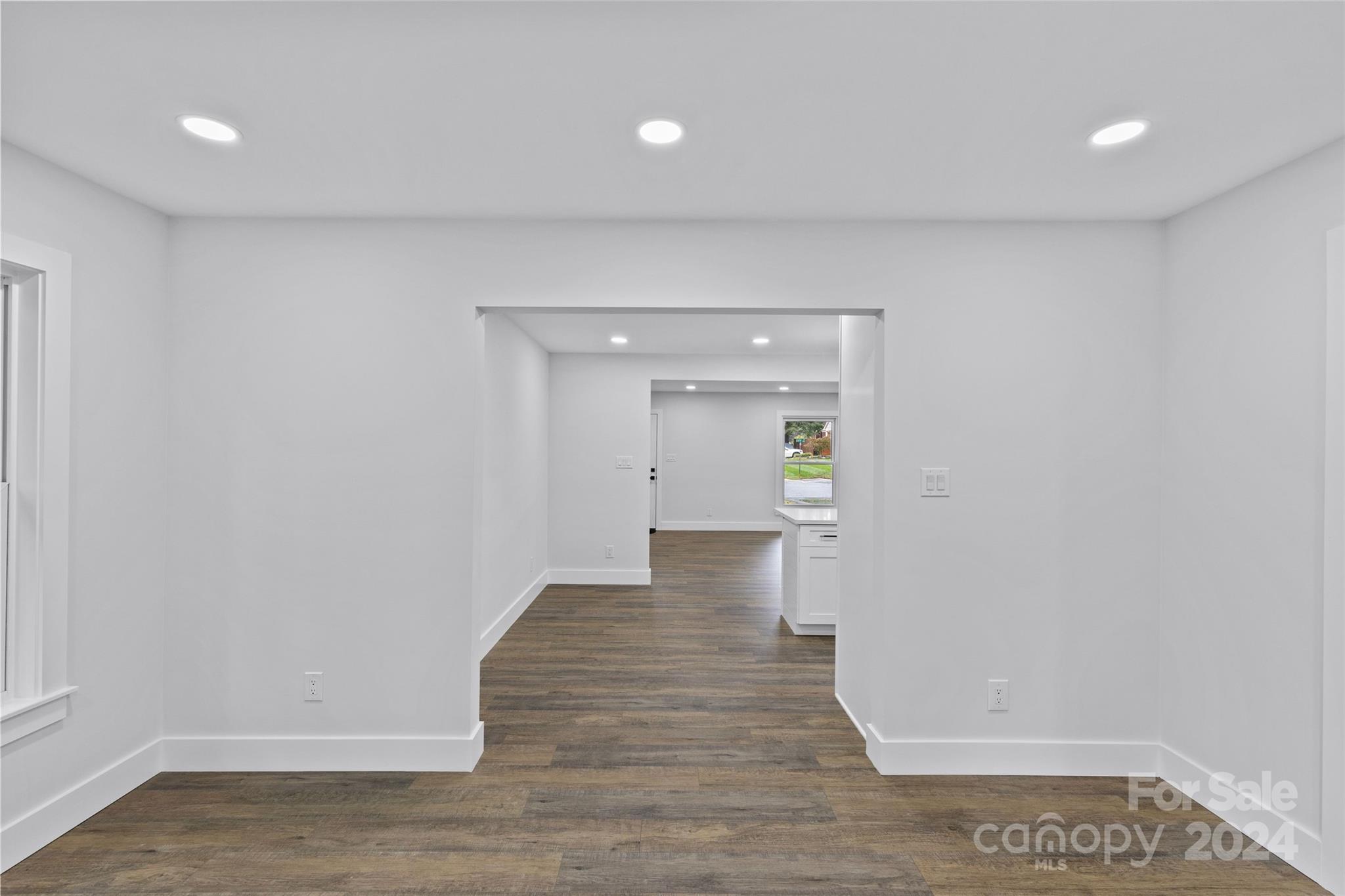 5745 Ruth Drive Charlotte, NC 28215 - Photo 18 of 42 a view of a hallway with wooden floor and a bathroom