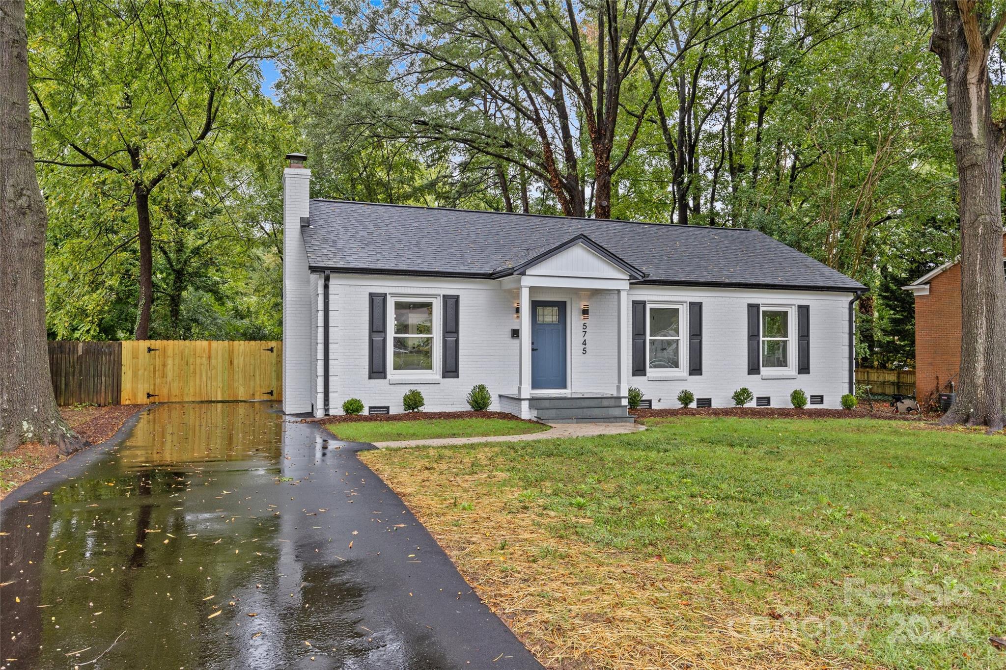 5745 Ruth Drive Charlotte, NC 28215 - Photo 2 of 42 a front view of a house with a garden and porch
