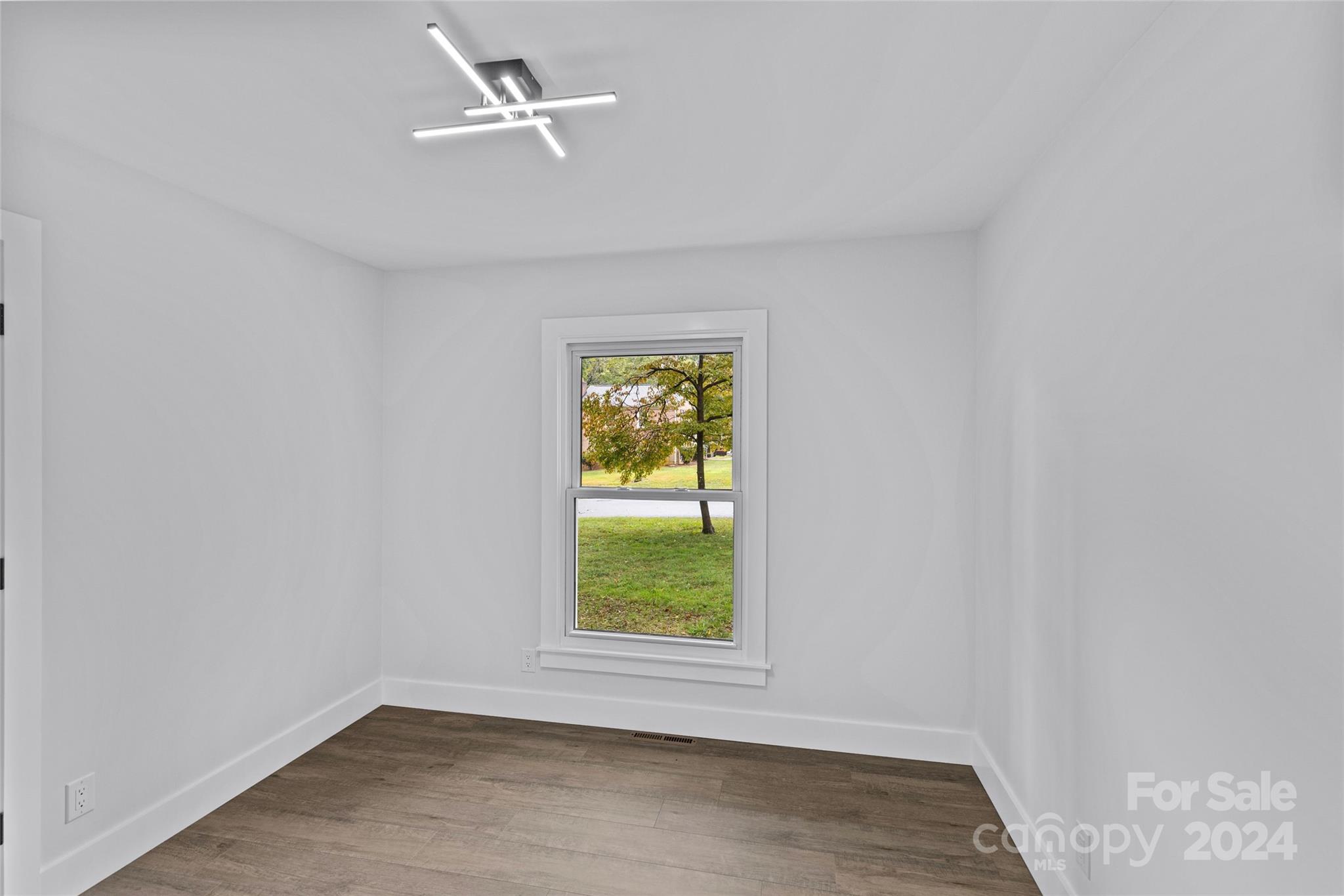 5745 Ruth Drive Charlotte, NC 28215 - Photo 21 of 42 an empty room with a window and wooden floor
