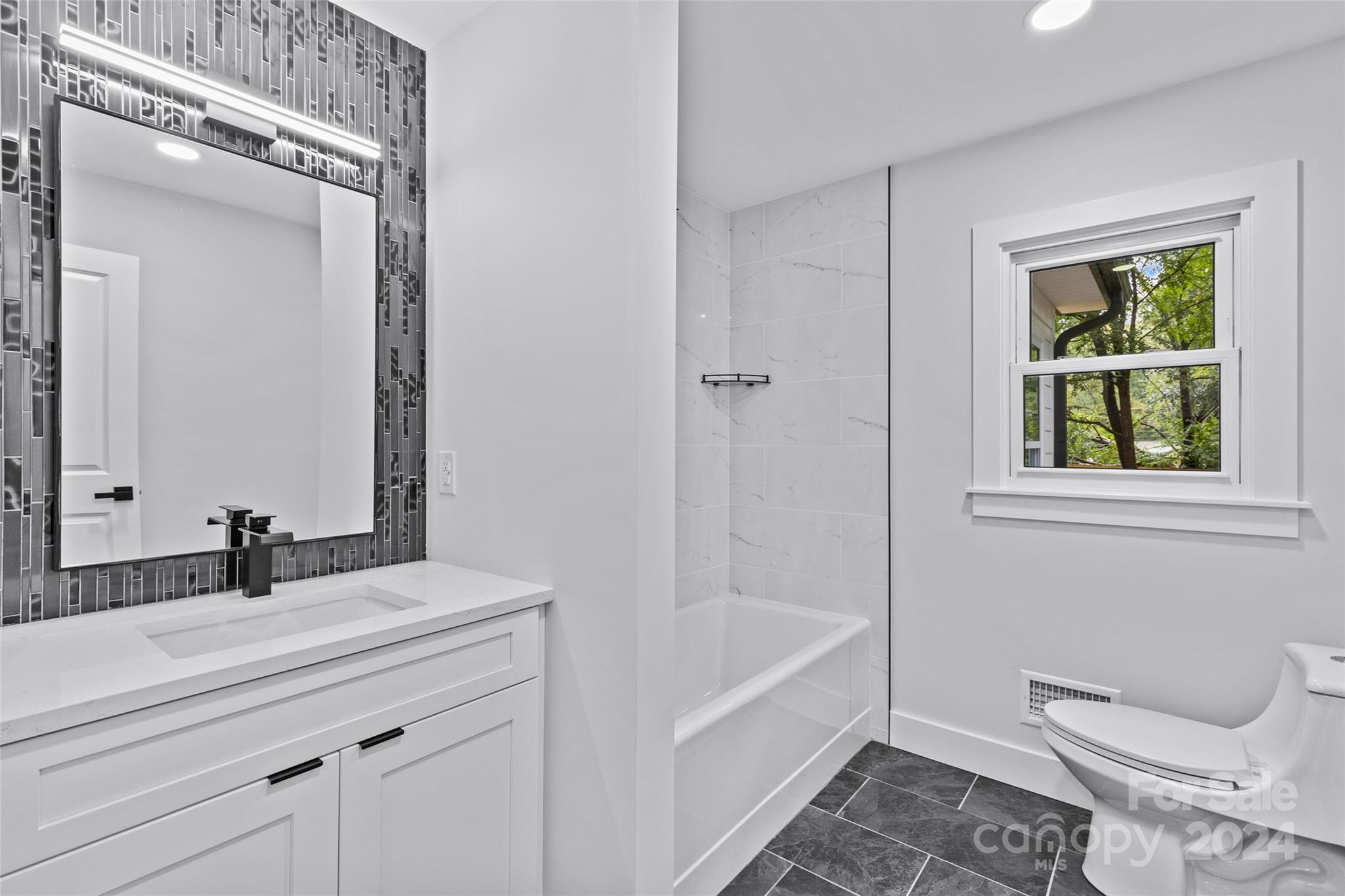 5745 Ruth Drive Charlotte, NC 28215 - Photo 23 of 42 a bathroom with a sink a toilet and bathtub
