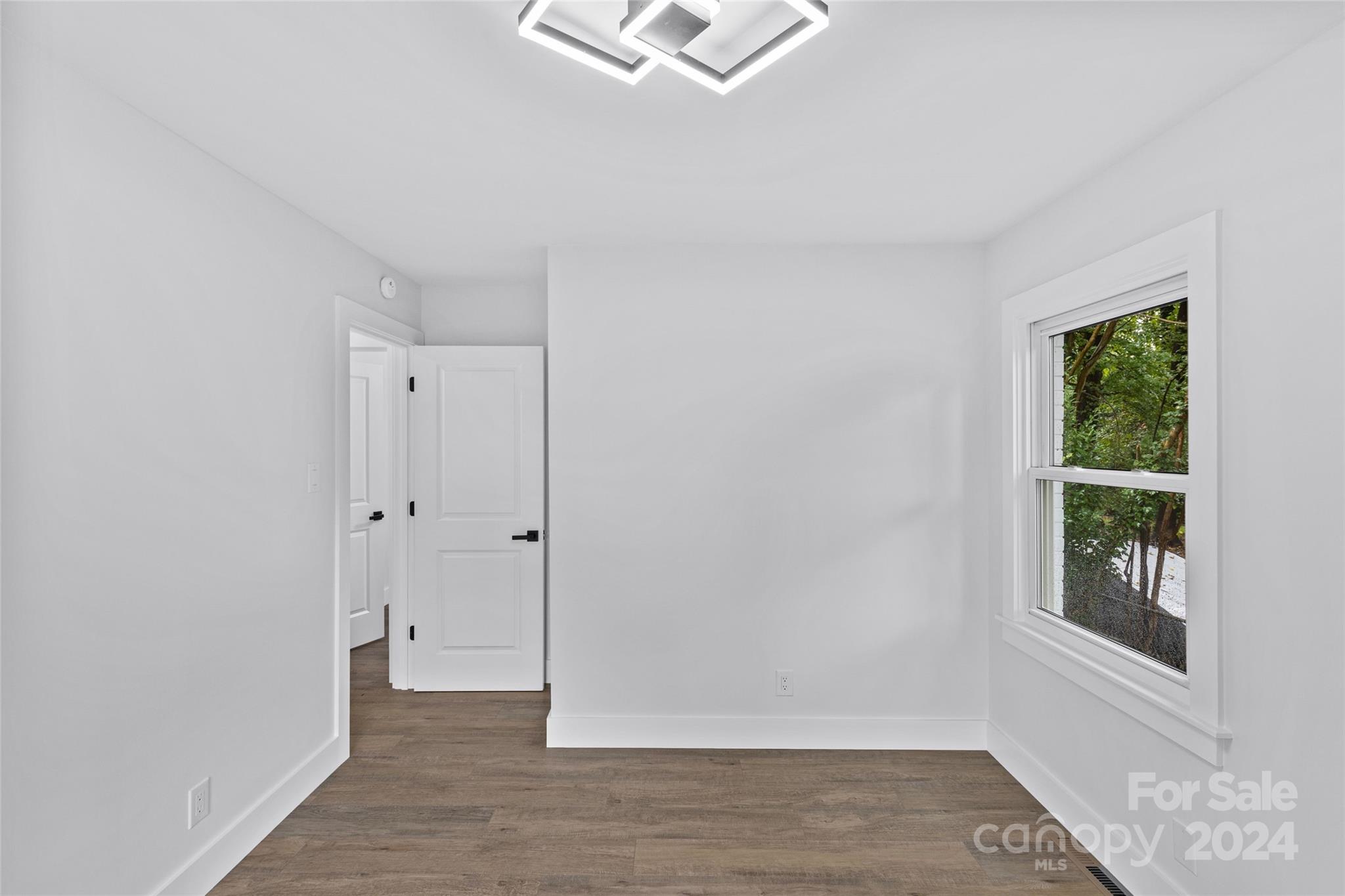 5745 Ruth Drive Charlotte, NC 28215 - Photo 26 of 42 a view of an empty room with wooden floor and a window