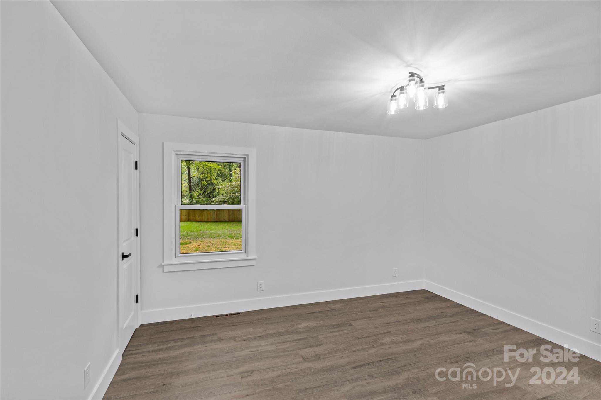 5745 Ruth Drive Charlotte, NC 28215 - Photo 27 of 42 wooden floor in an empty room with a window