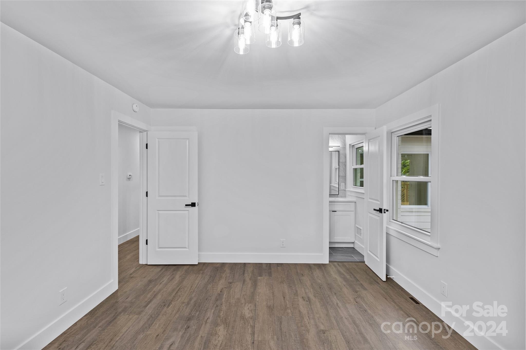 5745 Ruth Drive Charlotte, NC 28215 - Photo 29 of 42 wooden floor in an empty room with a window