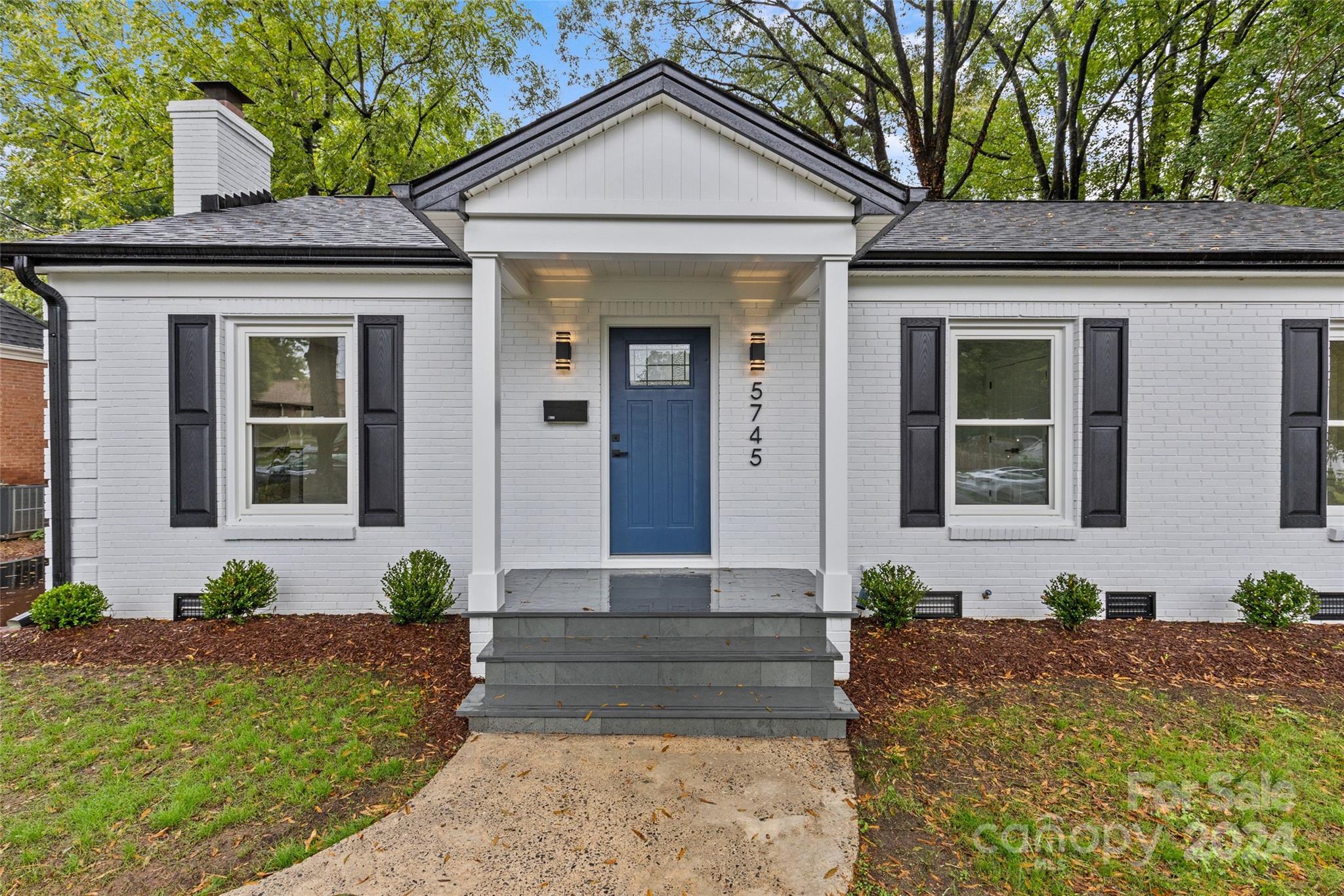 5745 Ruth Drive Charlotte, NC 28215 - Photo 3 of 42 a front view of a house with potted plants