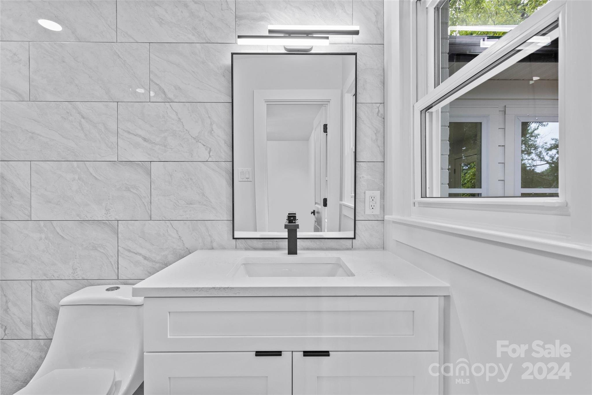 5745 Ruth Drive Charlotte, NC 28215 - Photo 32 of 42 a bathroom with a sink and mirror