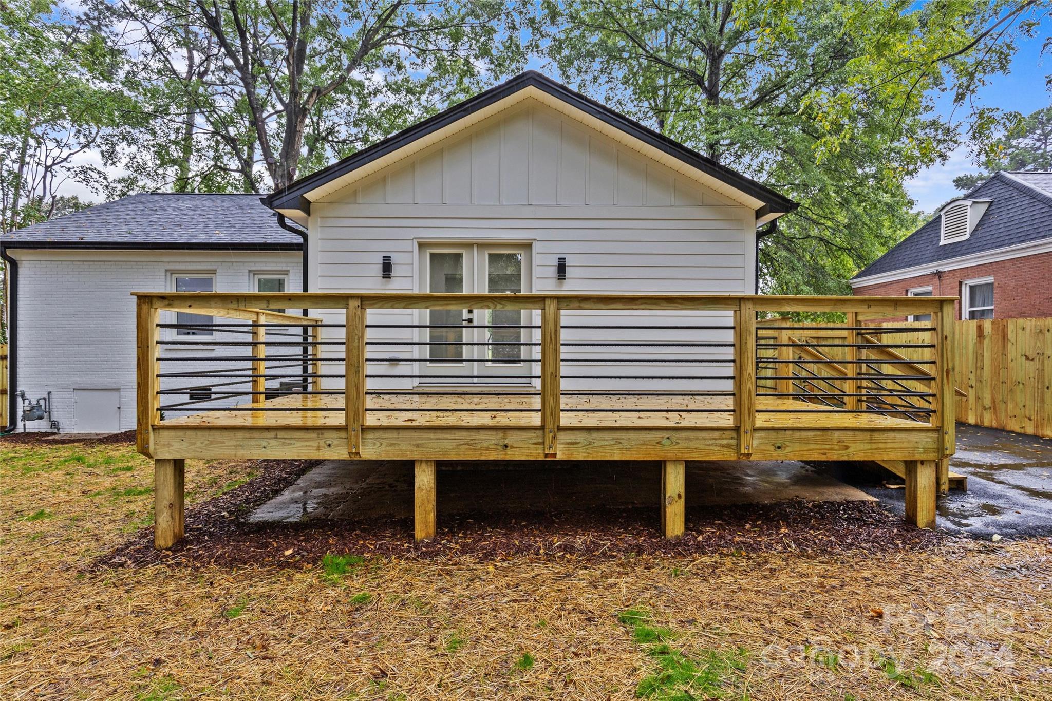 5745 Ruth Drive Charlotte, NC 28215 - Photo 42 of 42 a view of a house with a yard chairs and wooden fence
