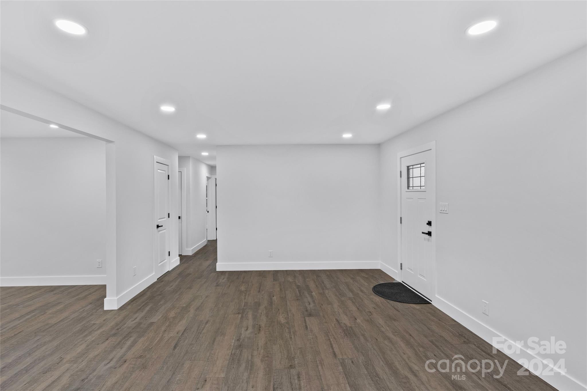 5745 Ruth Drive Charlotte, NC 28215 - Photo 7 of 42 a view of a room with wooden floors and white walls