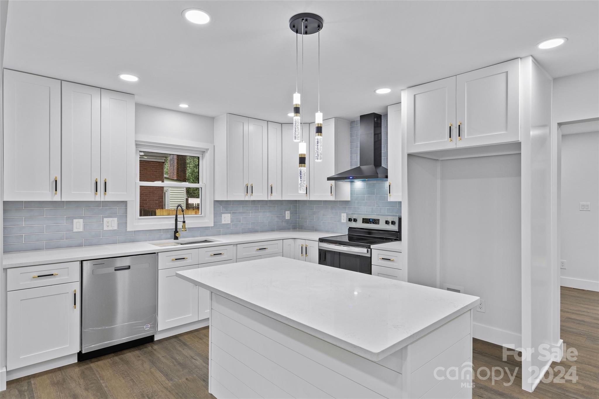 5745 Ruth Drive Charlotte, NC 28215 - Photo 10 of 42 a kitchen with a sink a stove a refrigerator and cabinets