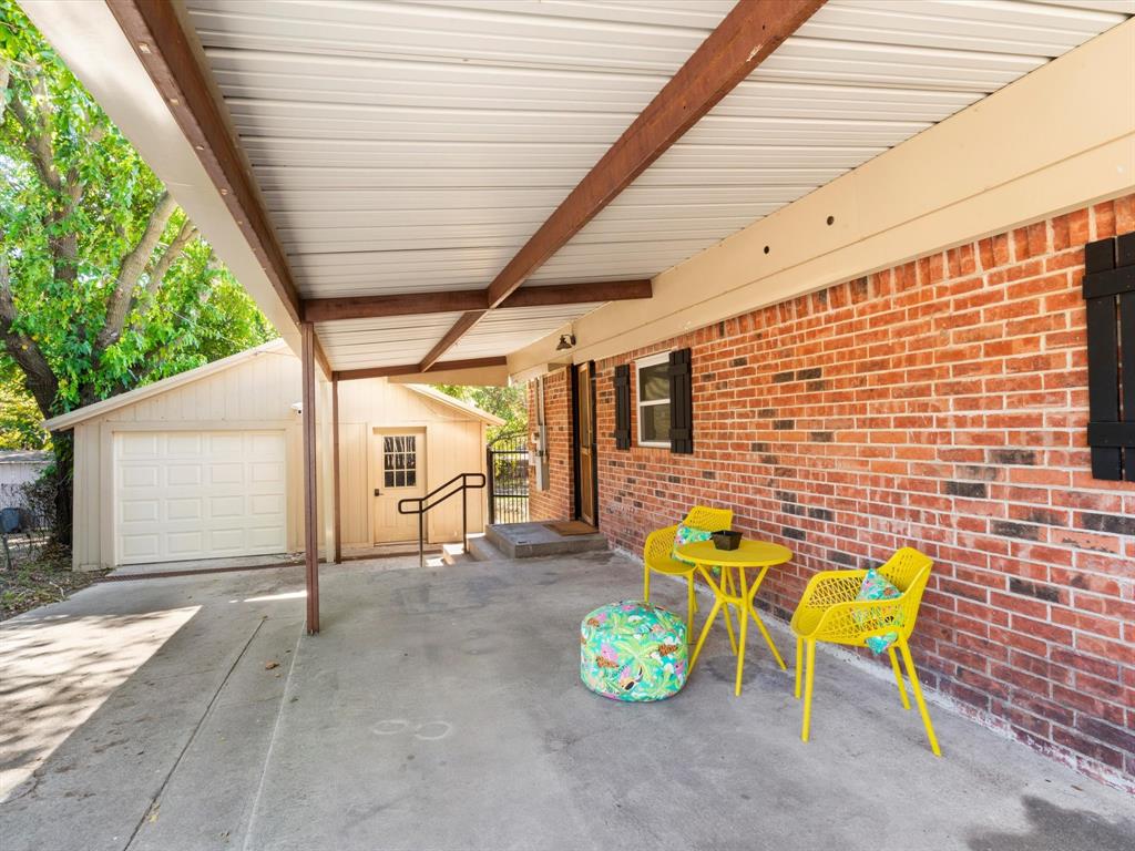 901 South Lane Street Decatur, TX 76234 - Photo 18 of 23 View of patio and garage with workshop and laundry