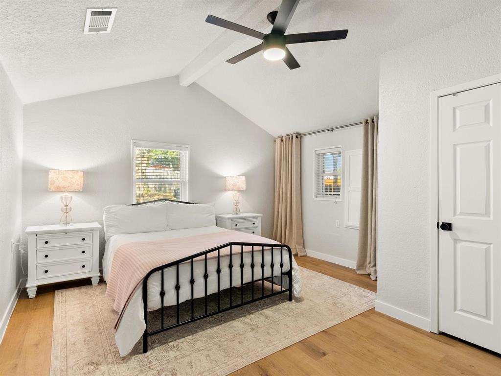 901 South Lane Street Decatur, TX 76234 - Photo 8 of 23 Bedroom featuring ceiling fan, vaulted ceiling with beams, a textured ceiling, and light hardwood / wood-style flooring