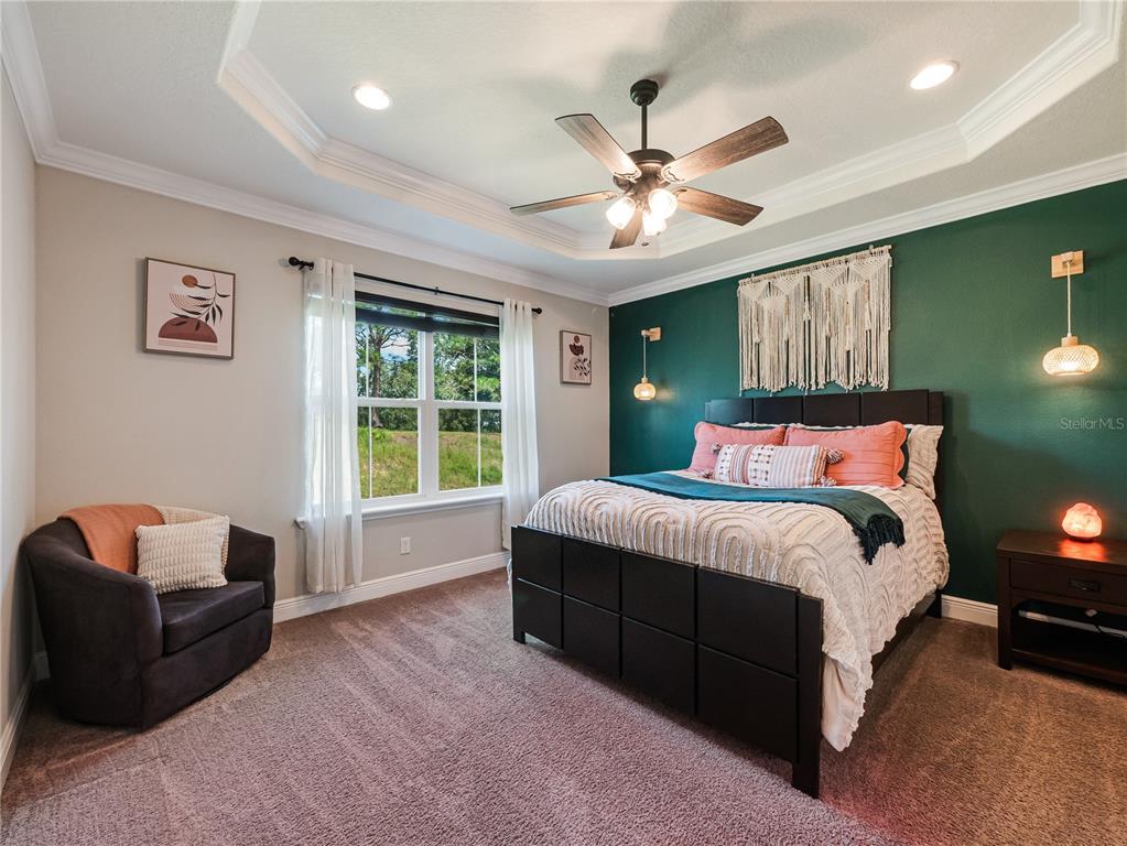 8416 Magnificent Road Groveland, FL 34736 - Photo 11 of 28 a bedroom with a bed couch and window