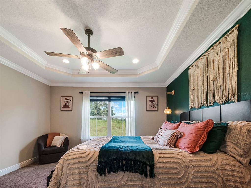 8416 Magnificent Road Groveland, FL 34736 - Photo 12 of 28 a bedroom with a large bed and a window