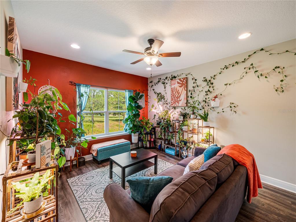 8416 Magnificent Road Groveland, FL 34736 - Photo 18 of 28 a living room with furniture and a large window