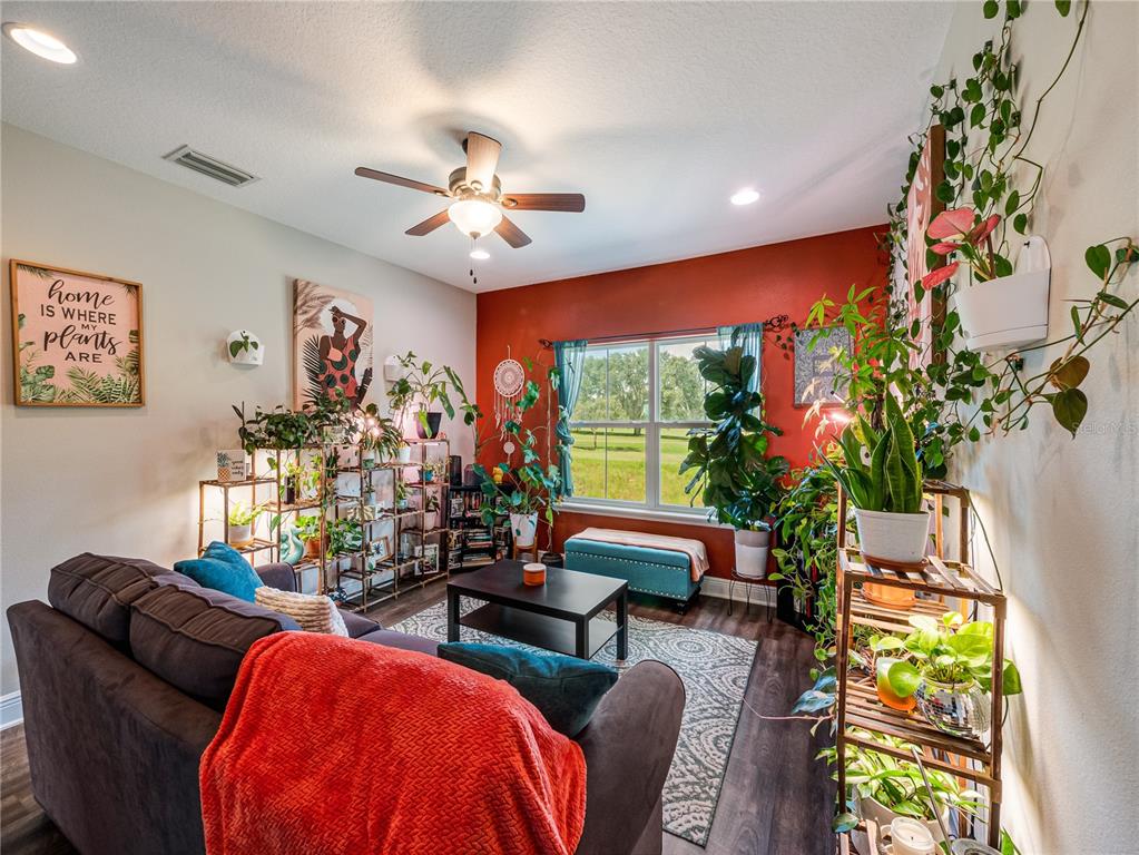 8416 Magnificent Road Groveland, FL 34736 - Photo 19 of 28 a living room with furniture a chandelier and a window