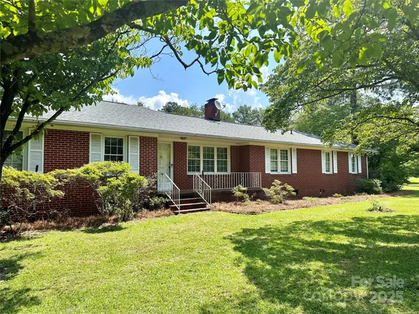 a front view of house with yard and outdoor seating