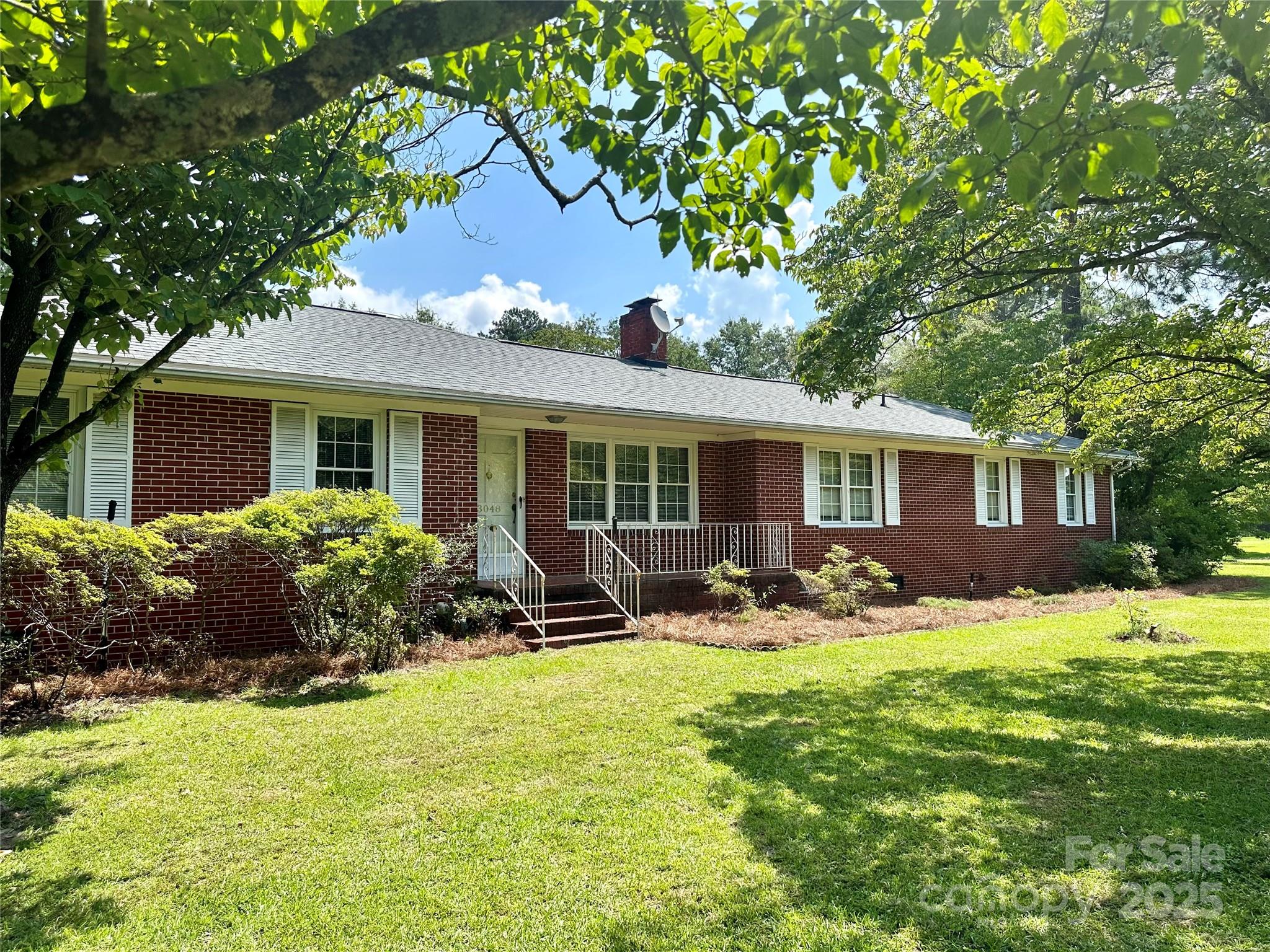 a front view of house with yard and outdoor seating