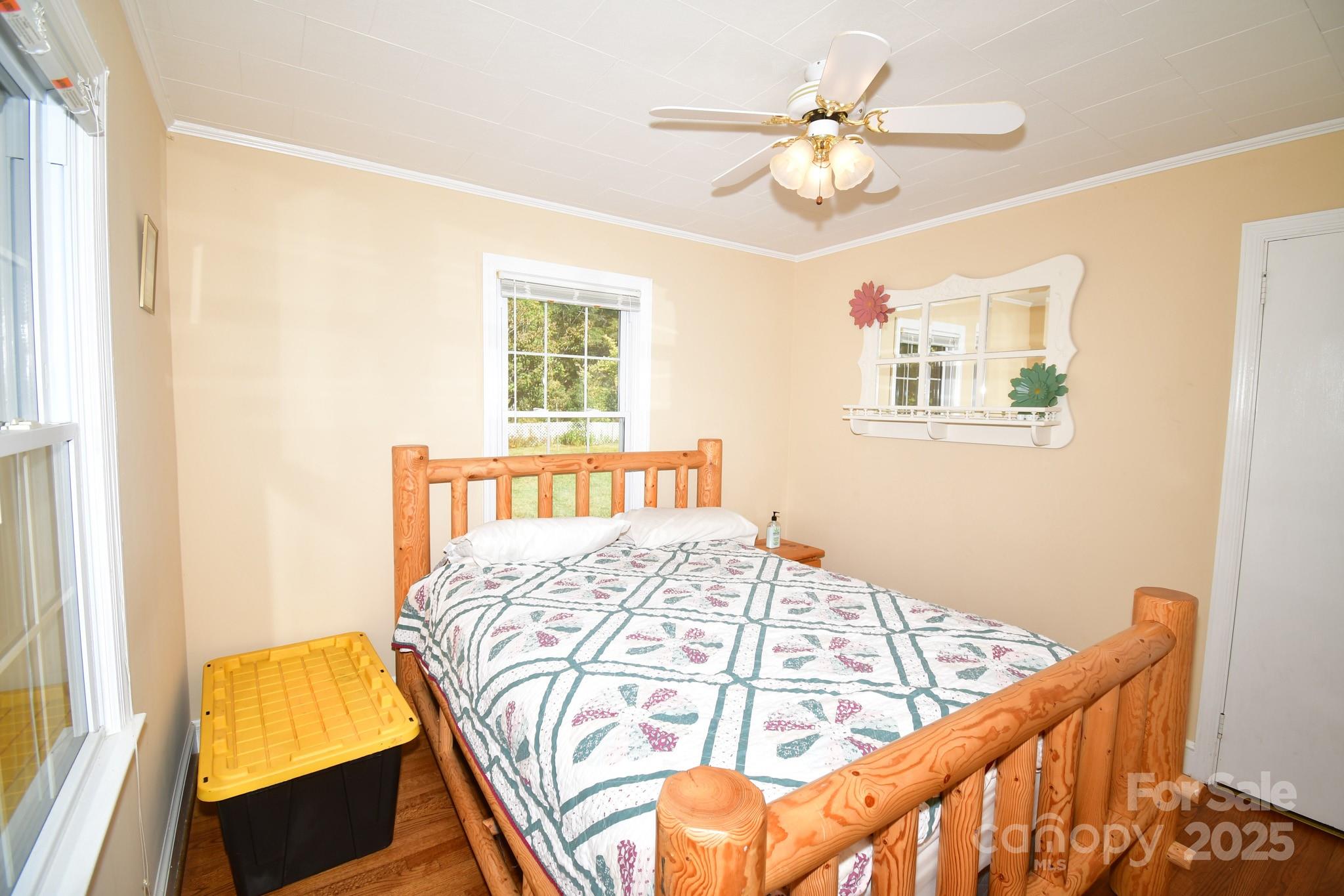 3048 Timrod Road Bethune, SC 29009 - Photo 11 of 26 a bedroom with a bed and a chandelier