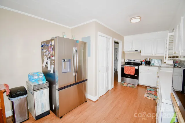a kitchen with stainless steel appliances a refrigerator and wooden cabinets
