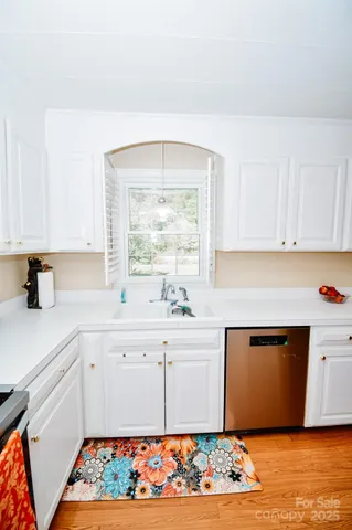 a kitchen with stainless steel appliances granite countertop a sink and a microwave