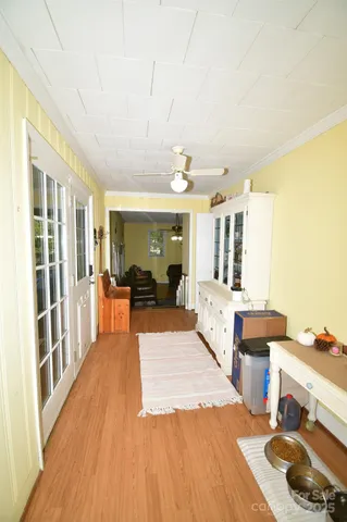 a large room with wooden floor and furniture