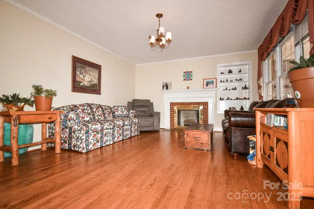 a living room with furniture fireplace and flat screen tv