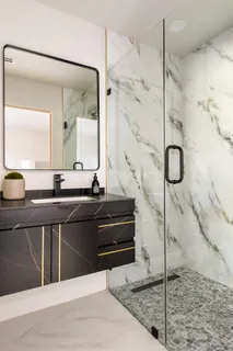 a bathroom with a tub sink and mirror