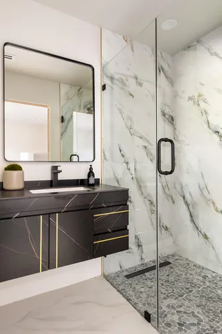 a bathroom with a tub sink and mirror