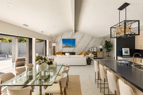 a living room with fireplace furniture and a large window