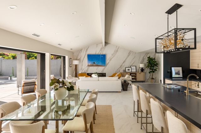 a living room with fireplace furniture and a large window