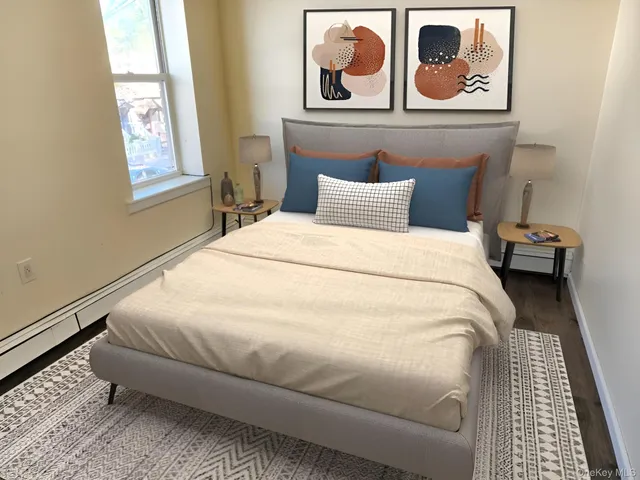 a large bed sitting in a bedroom next to a window