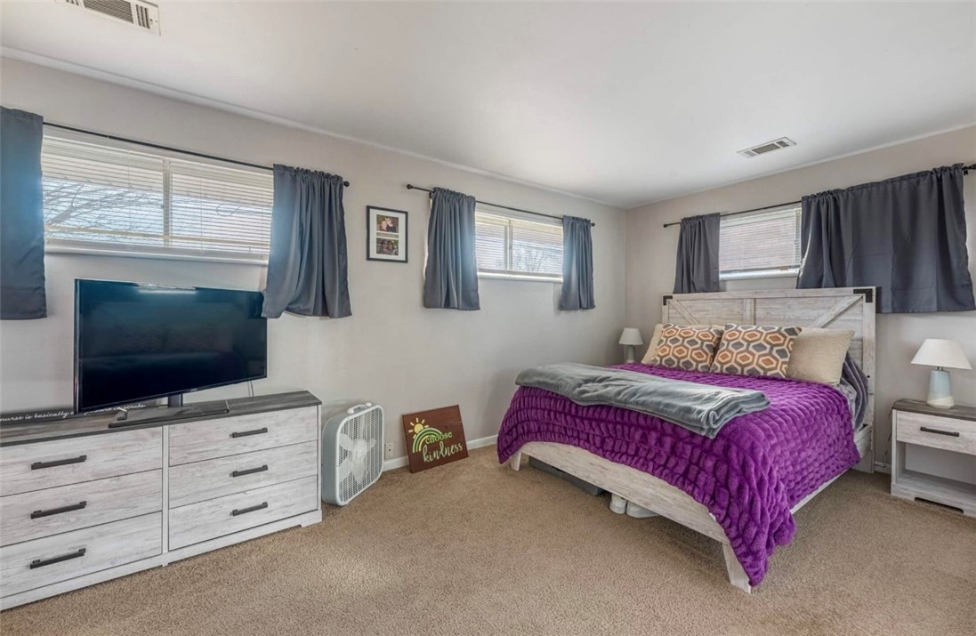 10 Monroe Road Lebanon, OH 45036 - Photo 6 of 14 This spacious bedroom offers ample natural light through multiple windows and comfortable carpeted flooring.