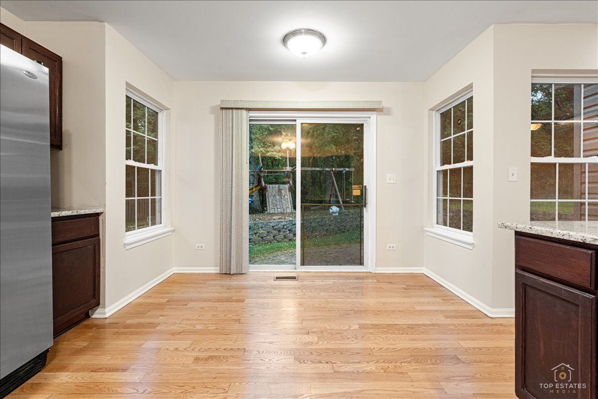 7 Eagle Court Streamwood, IL 60107 - Photo 9 of 31 a view of an empty room with a window and wooden floor