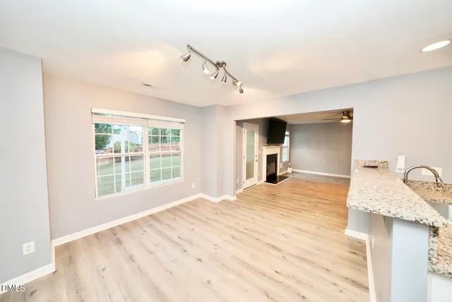a backyard of a house with lots of green space and trampoline