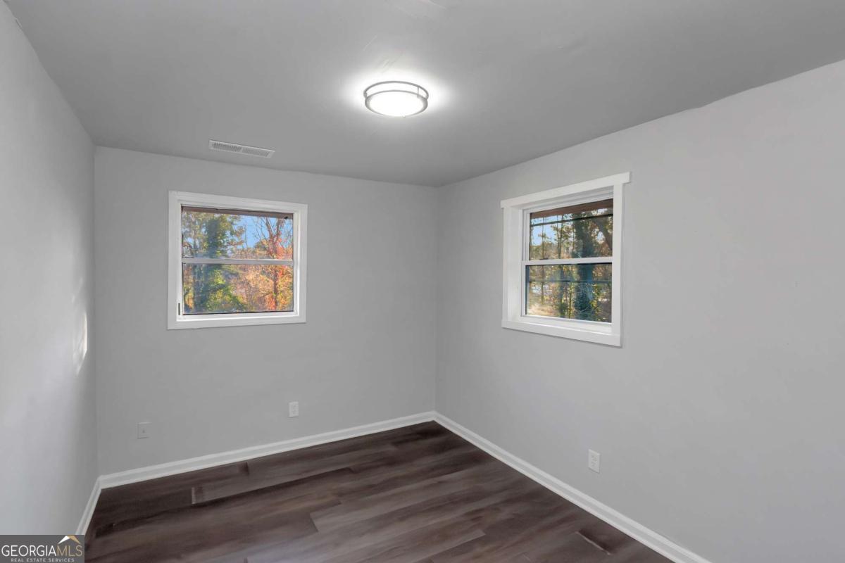 1829 Joy Lake Road Morrow, GA 30260 - Photo 26 of 26 a view of an empty room with wooden floor and a window