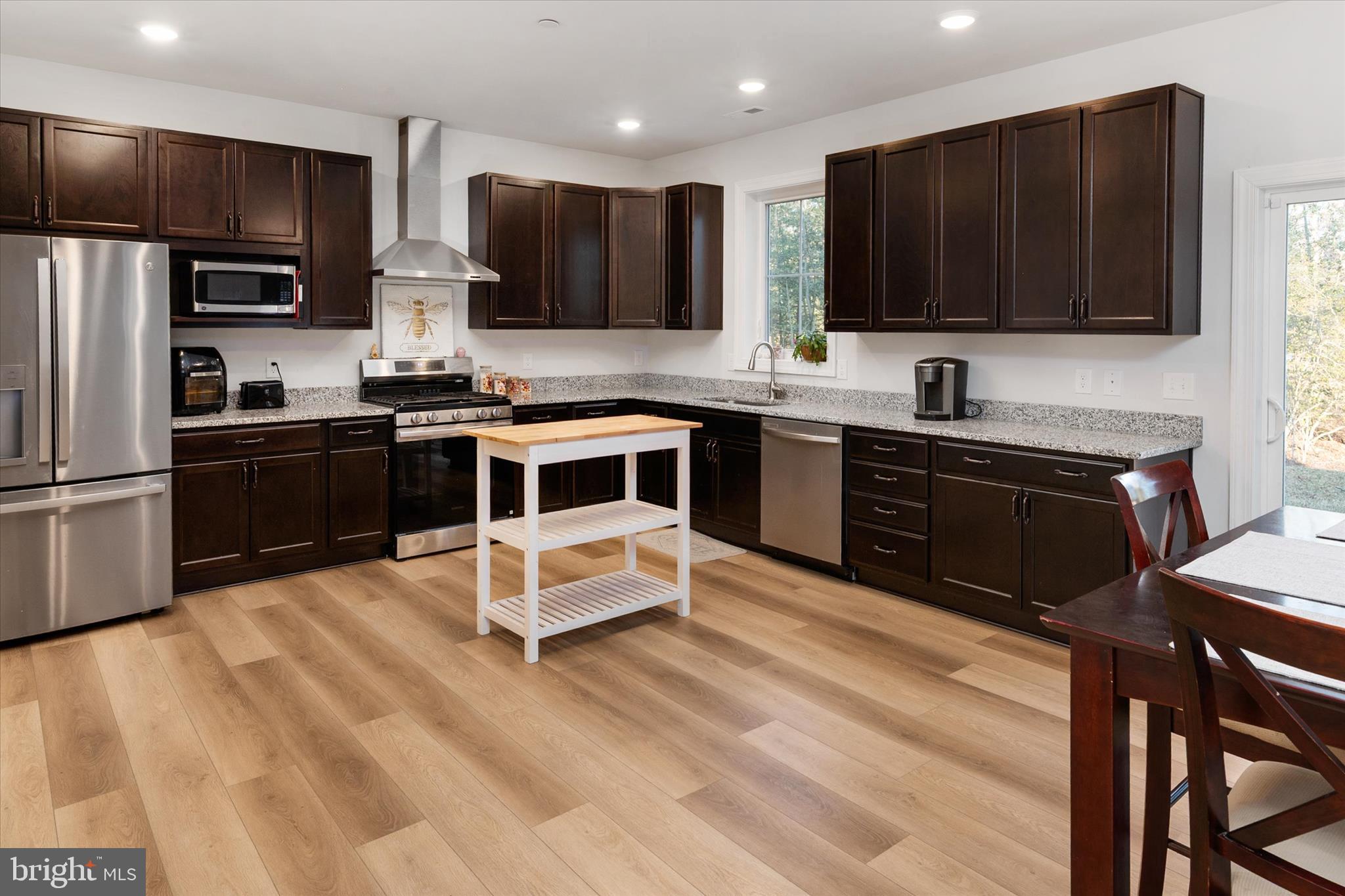 720 Bridge Drive Pasadena, MD 21122 - Photo 13 of 46 a kitchen with stainless steel appliances a stove a sink a refrigerator and cabinets