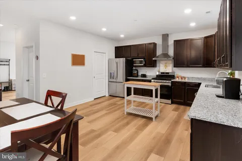 a kitchen with a sink stove top oven and cabinets