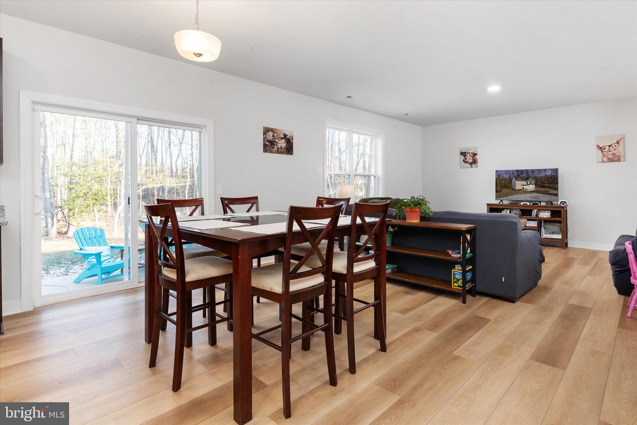 720 Bridge Drive Pasadena, MD 21122 - Photo 16 of 46 a view of a dining room with furniture and wooden floor
