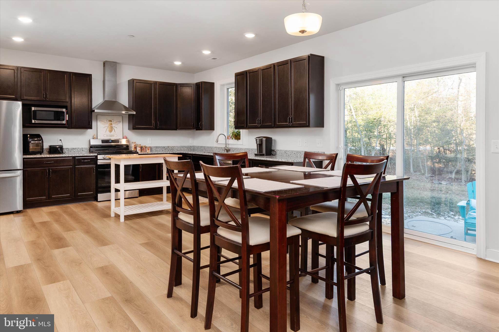 720 Bridge Drive Pasadena, MD 21122 - Photo 17 of 46 a view of a dining room with furniture window and wooden floor
