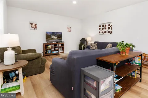 a living room with furniture and kitchen view